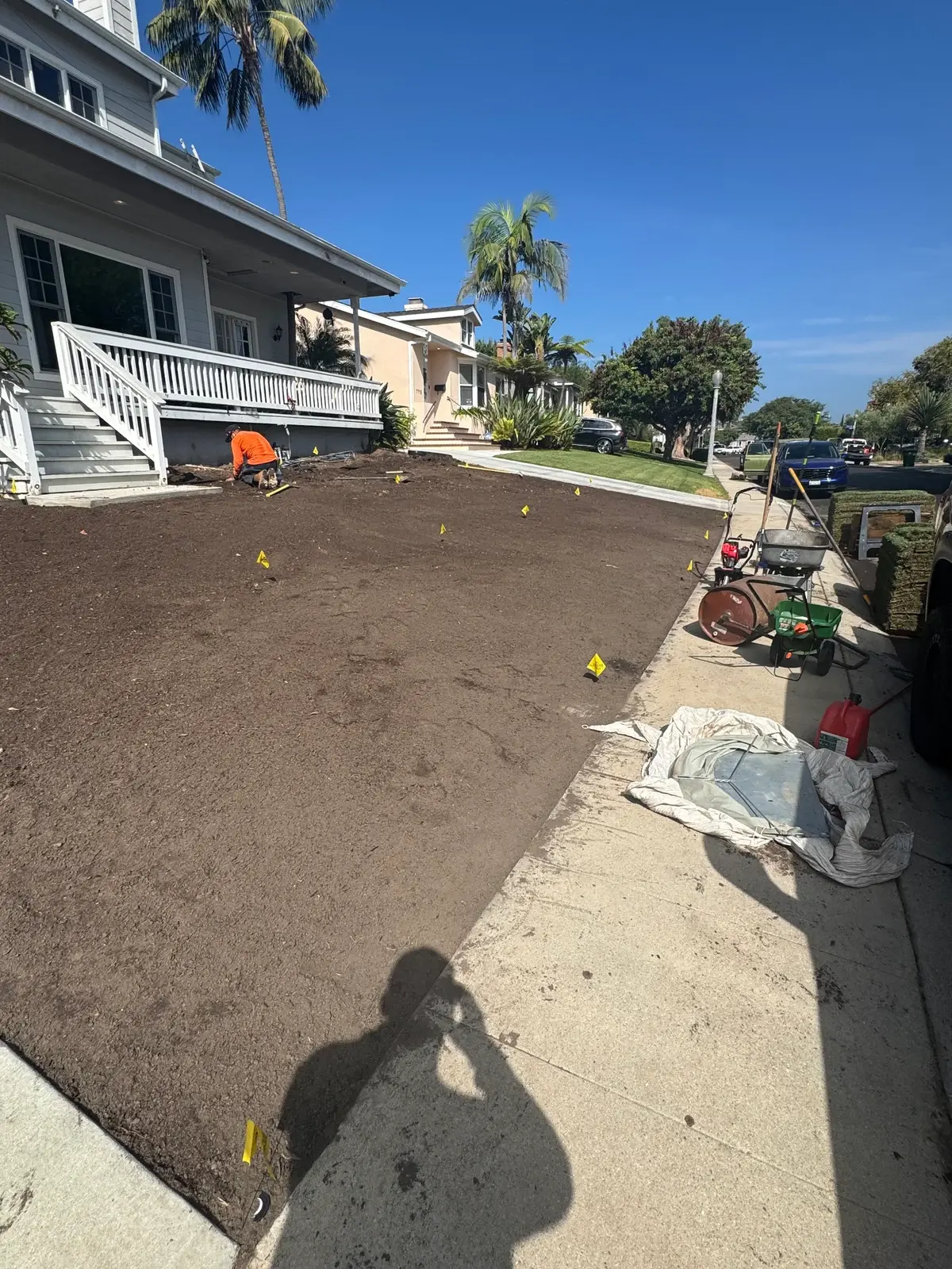 Prepared soil and work underway before laying sod